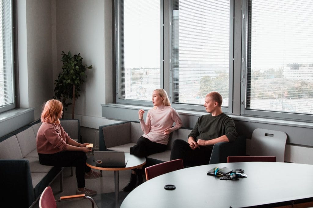 article image: Everything about Condominiums. Three people are seated on sofas in the image, with a table and a computer in the centre.