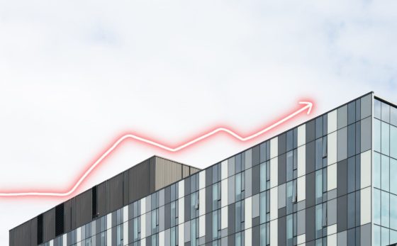 Article cover image: What is the Euribor rate? – image of a building with several glass windows. At the top, there is a red arrow pointing upwards.