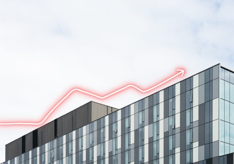 Article cover image: What is the Euribor rate? – image of a building with several glass windows. At the top, there is a red arrow pointing upwards.